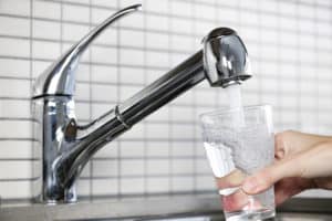 Well Water VS City Water: Filling glass of tap water 